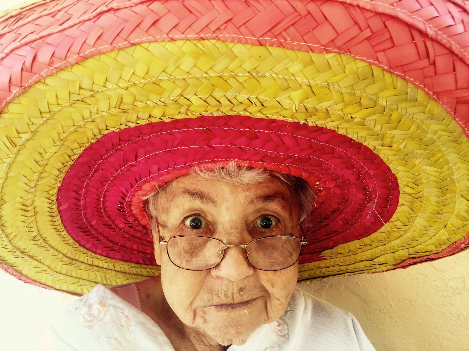 grandma using eyeglasses and wearing a sombrero - emphasizing the online entrepreneur grandma method of treating everyone like your grandma